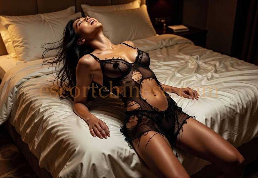 Woman in black lingerie relaxing on a bed
